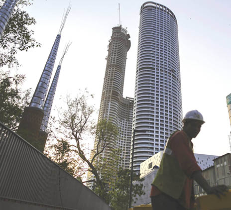 A worker stands at a construction site 