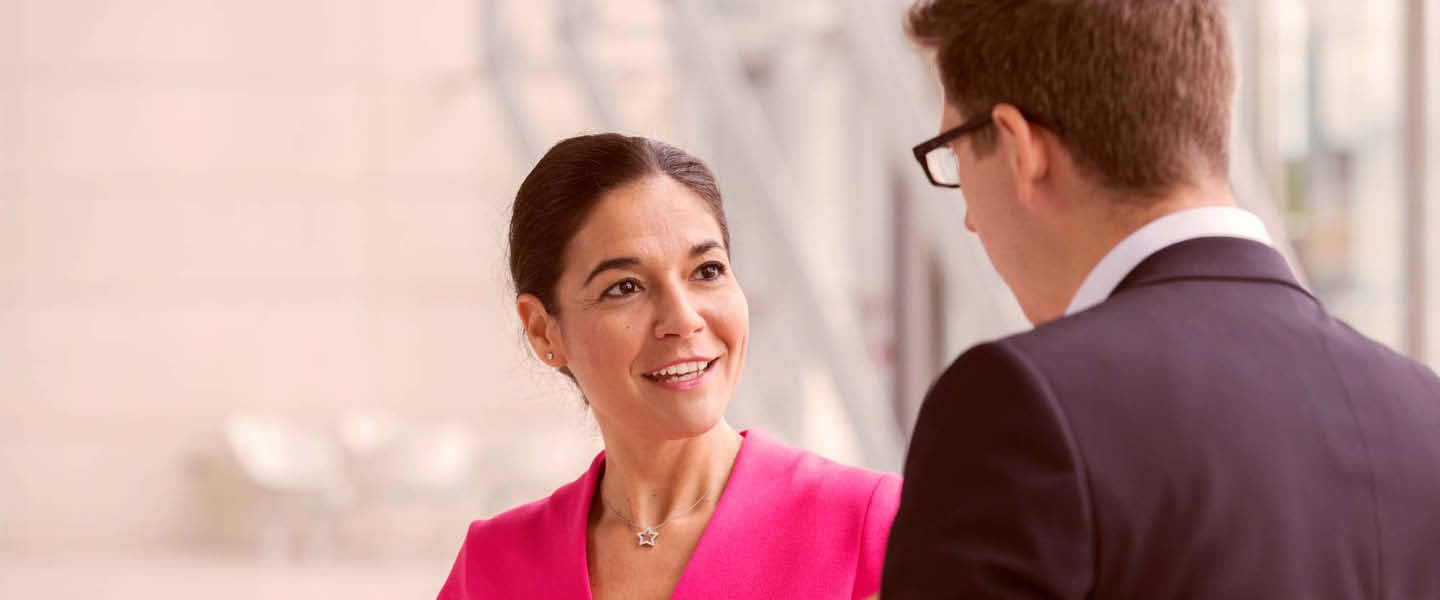 Two business people (man and woman) talking - generic photography